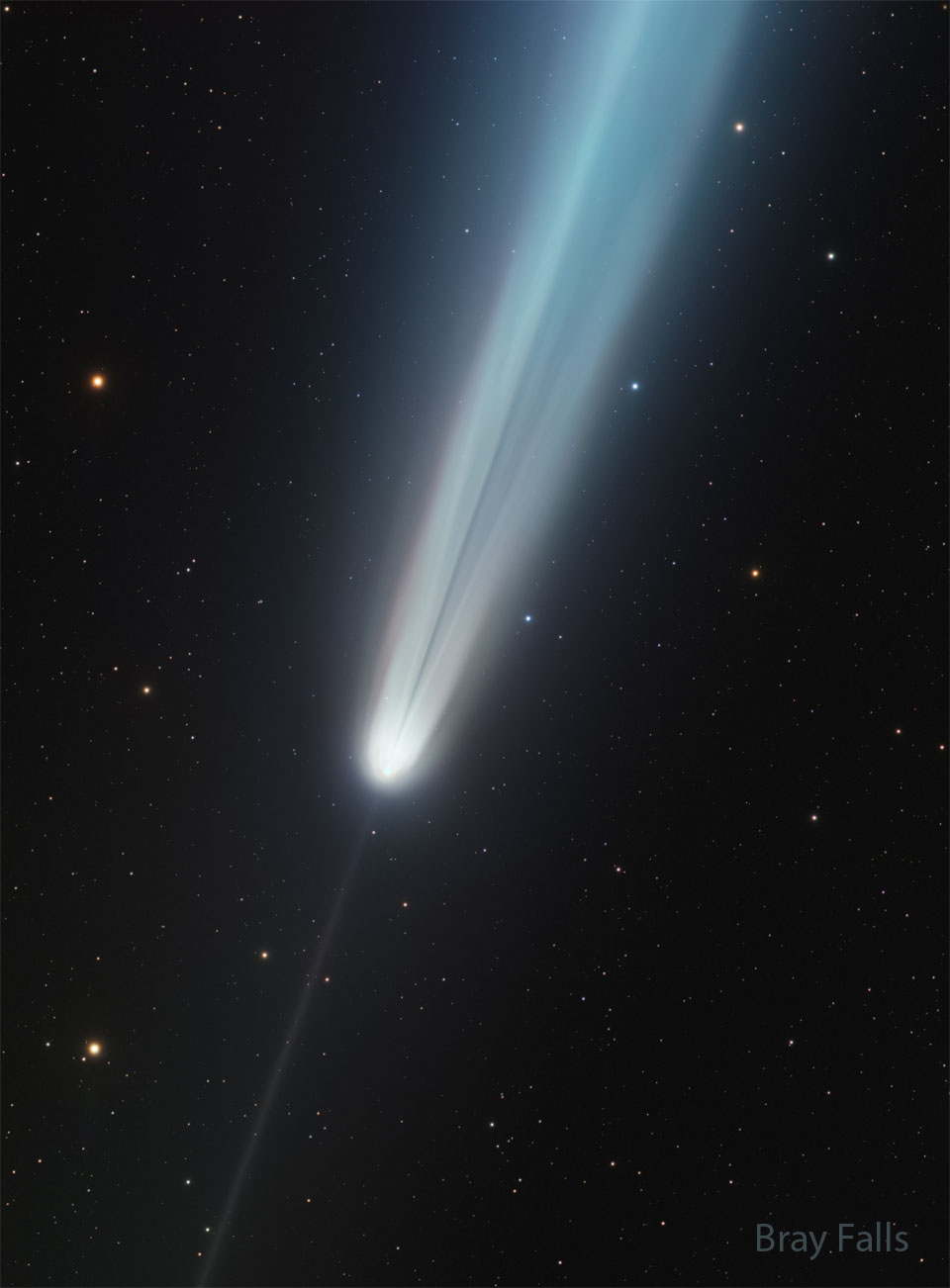 A starfield is shown that includes a bright comet.
A bright tail points to the upper right but has an
unusual dark streak in it. A thin anti-tail points
toward the lower left. 
Please see the explanation for more detailed information.