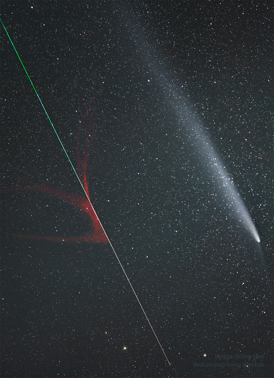 A star-filled sky has two streaks in the foreground. A green
and red streak toward the lower left was created by an ablating 
meteor, while the blue and white streak on the upper right is
the coma and tail of a comet. 
Please see the explanation for more detailed information.