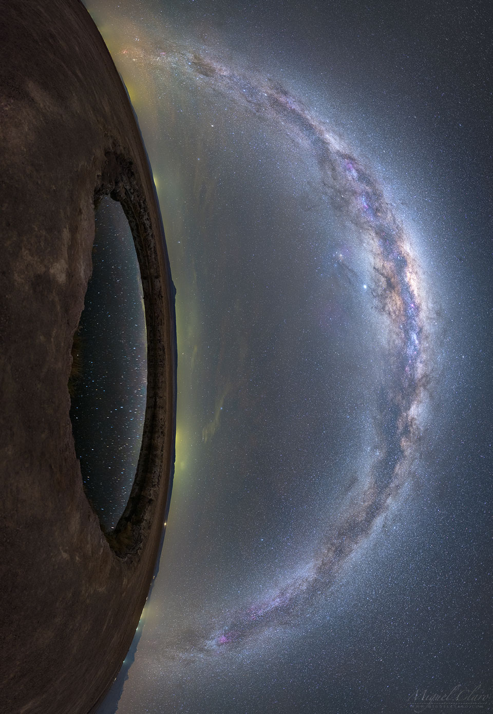 The image shows land on the left and a star filled
sky on the right. Prominent in the sky is the band of our
Milky Way Galaxy. On the left is a small circular lake 
that reflects some of the stars in the sky. Together, 
the land and lake look like an eye lookout out at the 
Milky Way. 
Please see the explanation for more detailed information.