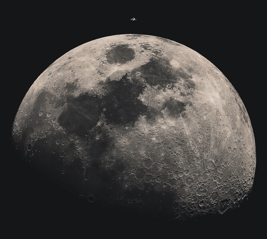 The relatively small International Space Station sits atop the image, about to transit in front of the
illuminated Moon. Please see the explanation for more detailed information.