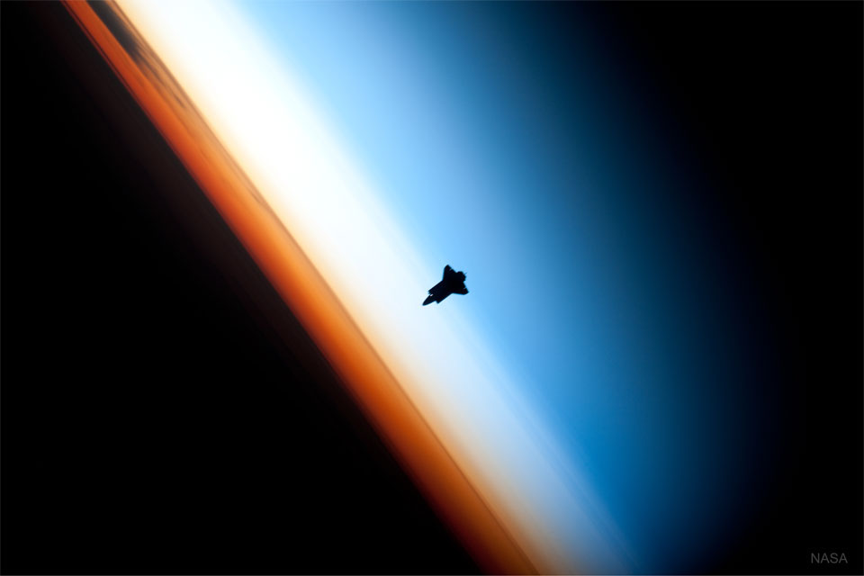 The featured image shows a the NASA space shuttle
approaching the International Space Station with the Earth's
atmosphere in the background. 
Please see the explanation for more detailed information.