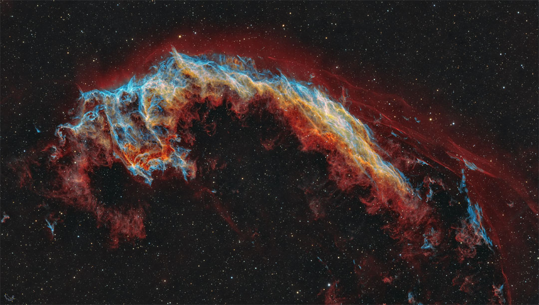 The featured image shows a starfield with a multi-coloured 
nebula in the centre. The nebula is quite
filamentary but appears to some like a bat.
Please see the explanation for more detailed information.