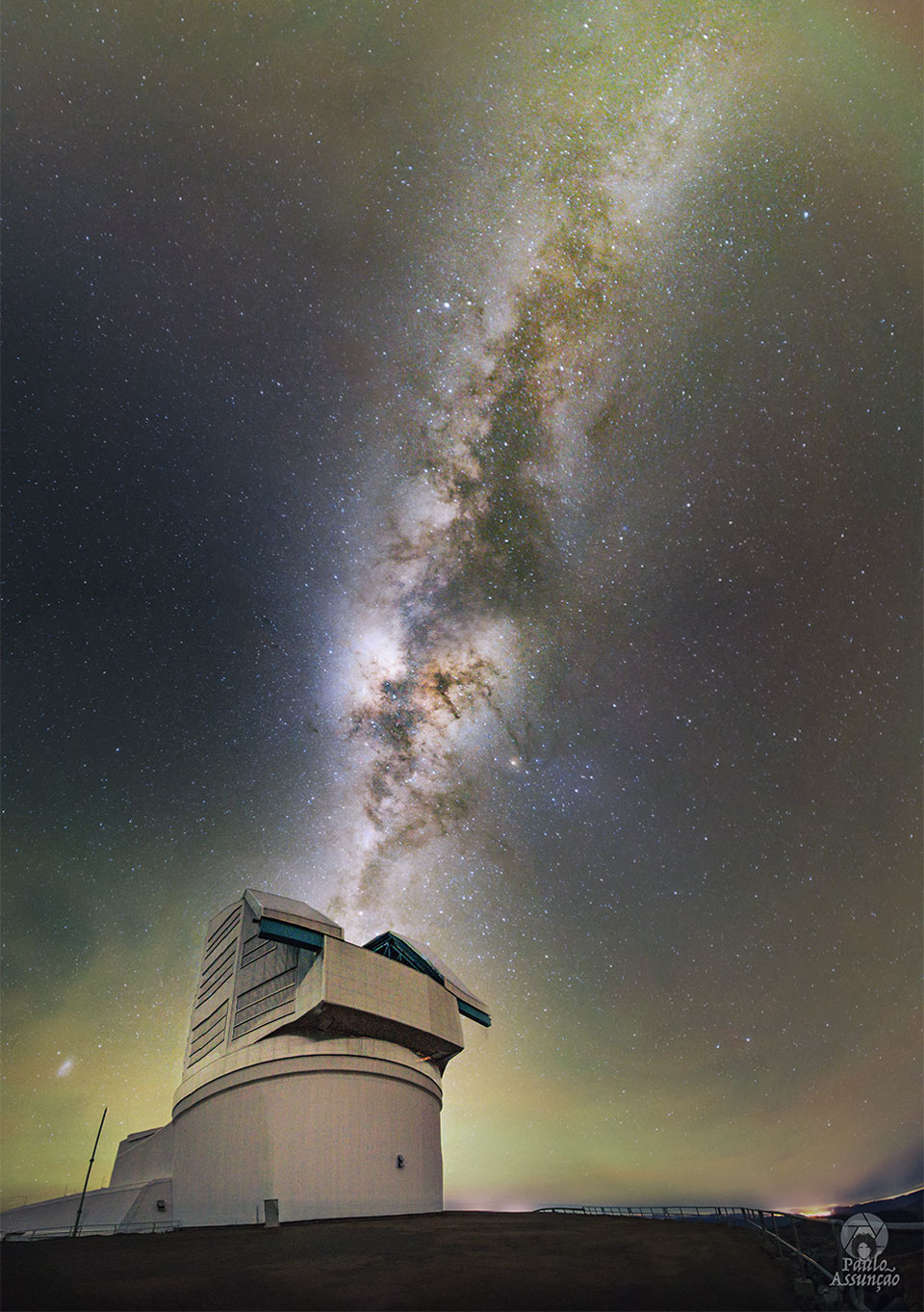 A large telescope appears on the left. The band of our
Milky Way Galaxy extends from the telescope to the upper
right of the image. The horizon has a slight glow.
Please see the explanation for more detailed information.